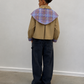 Veste courte beige à empiècements à carreaux contrastants