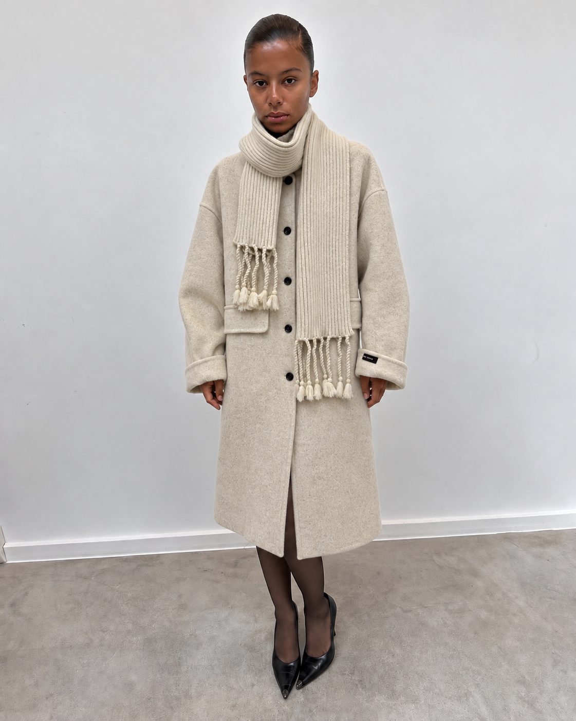 Manteau long écru, détail des franges